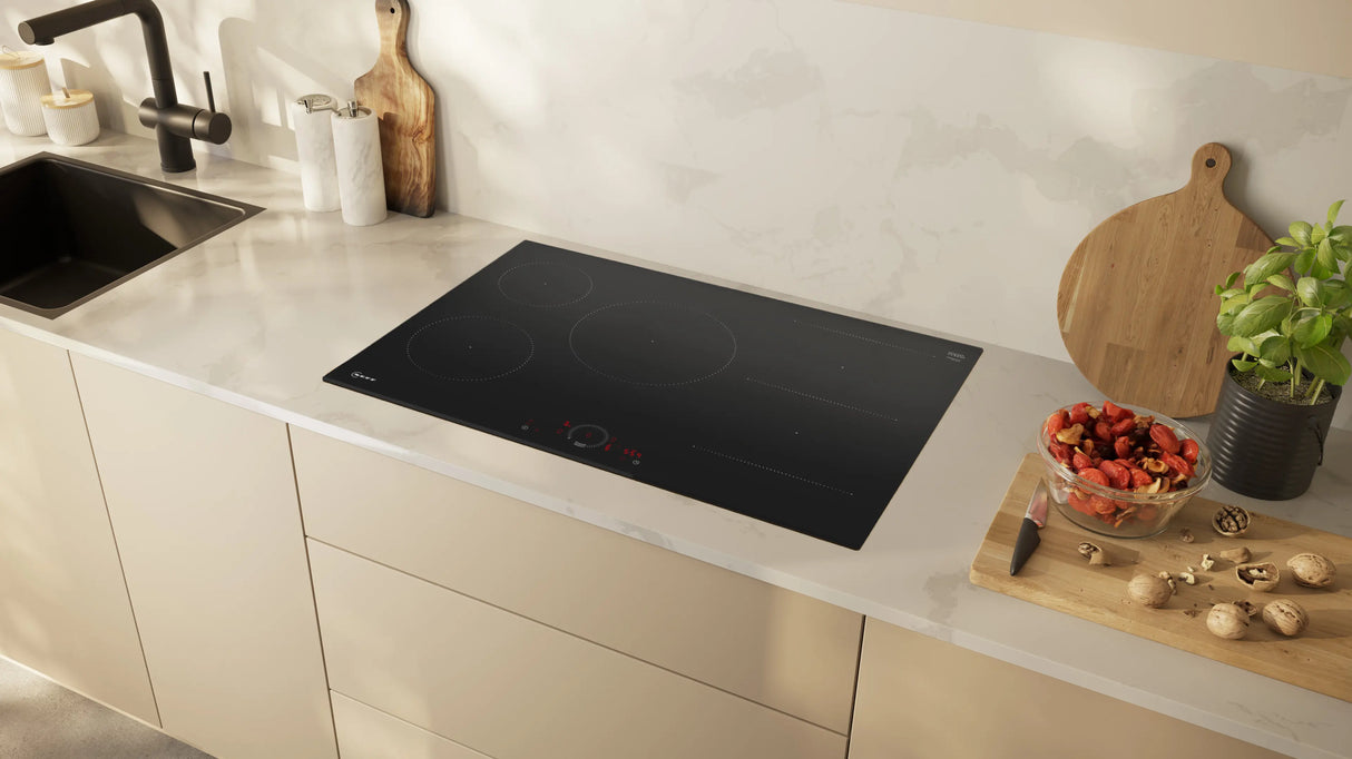 Neff T58FHW1L0 N70 80cm 5-Zone Induction Hob with Twist Touch® from HomeWise Appliances. Stock photo of the hob fitted in a worktop in a kitchen surround.
